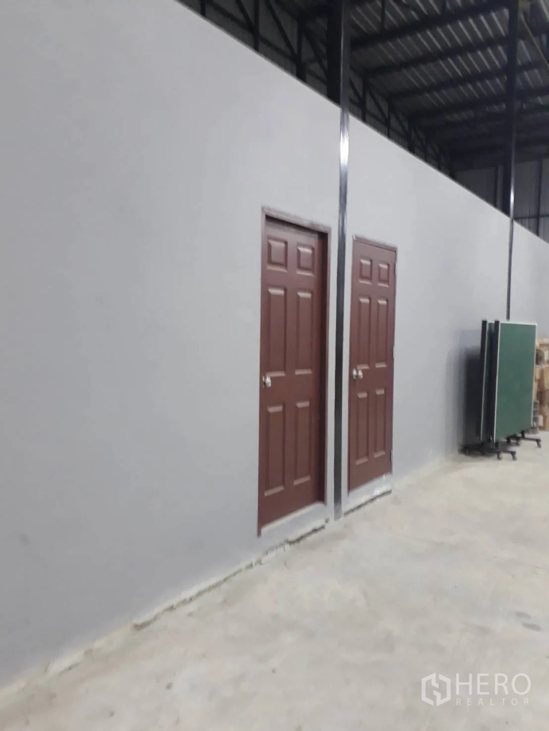 Warehouse for sale in Bang Len, Nakhon Pathom - Angled view of twin interior doors along the warehouse wall.