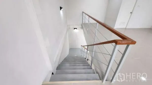 Factory for rent in Bang Bo, Samut Prakan - Bright stairwell with metal railing leading to the office level