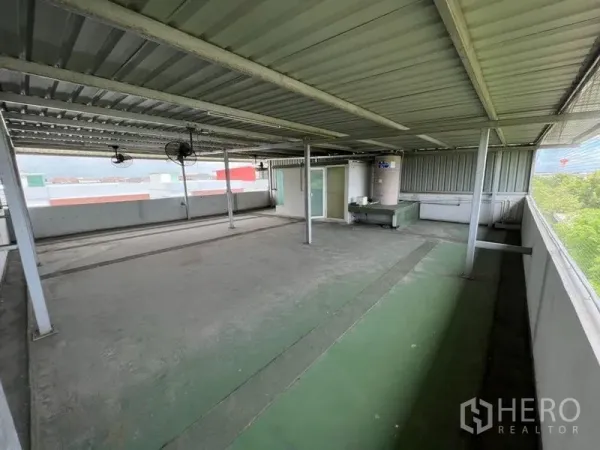 Home Office for rent or sale in Bang Phli, Samut Prakan - Large covered rooftop terrace with metal roof, ceiling fans, and utility area.