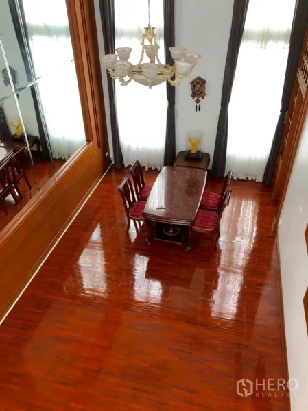 ทาวน์เฮาส์ ให้เช่าในKhlong Toei, Bangkok - พื้นที่รับประทานอาหารเพดานสูง โคมระย้า ม่านสูง และพื้นไม้เงางาม