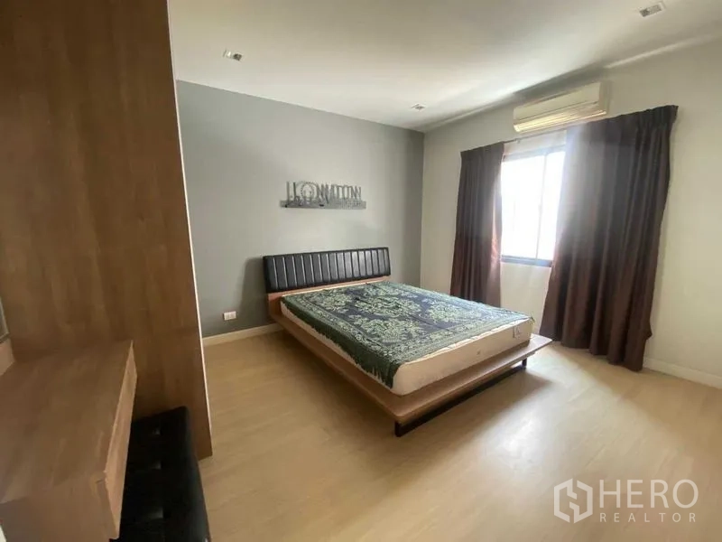Home Office for rent or sale in Bang Phli, Samut Prakan - Bedroom with platform bed, gray accent wall and window with curtains.