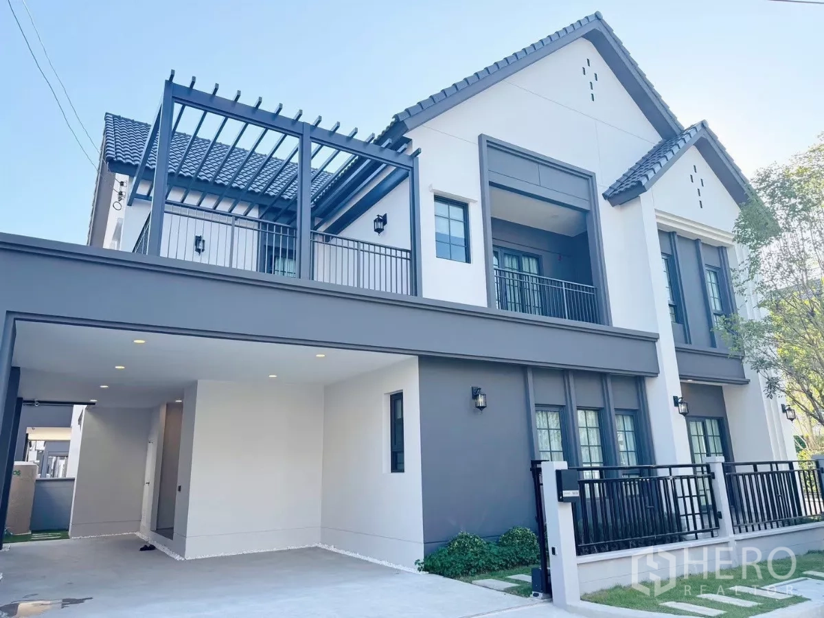 Detached House for rent or sale in Bang Phli, Samut Prakan - Modern two-storey detached house facade at Centro Bangna with covered carport and balconies.