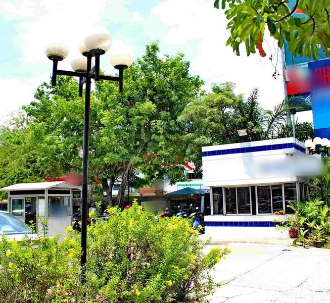 Office Space for rent in Lak Si, Bangkok - Landscaped office compound entrance with a security gatehouse and mature trees.