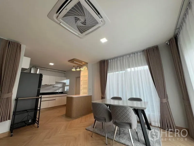 Detached House for rent in Bang Phli, Samut Prakan - Dining zone next to kitchen with full-height curtains and modern ceiling light.