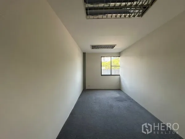Office Space for rent - Compact private office with a window and carpeted flooring.