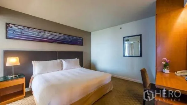 Condominium for rent in Bang Kho Laem, Bangkok - Second bedroom with king bed, work desk, mirror and soft ambient lighting.