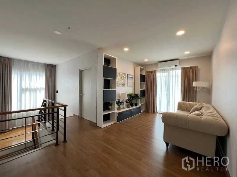 Detached House for rent in Bang Phli, Samut Prakan - Upstairs family lounge with built-in shelving, sofa and wood flooring.