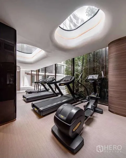 Condominium for rent - Fitness room with treadmills and an elliptical under skylights overlooking a garden.