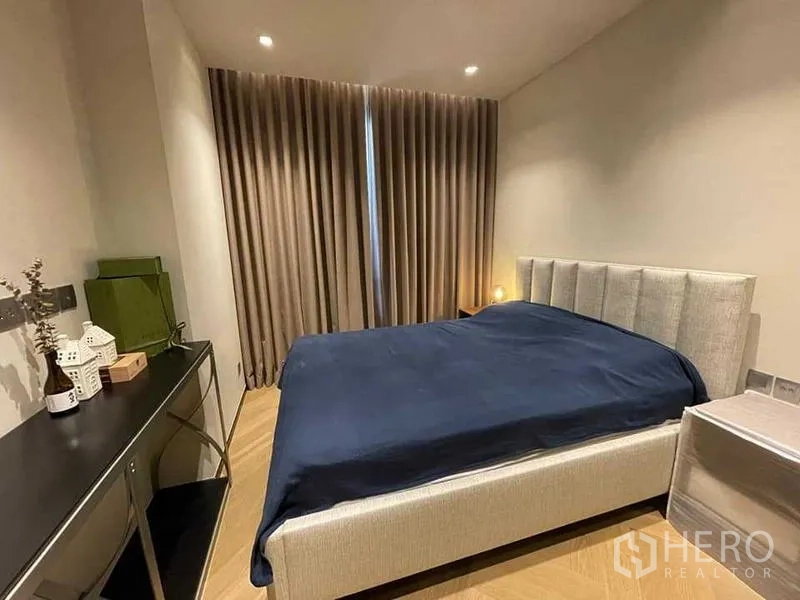 Condominium for rent or sale - Second bedroom with upholstered bed, desk and blackout curtains