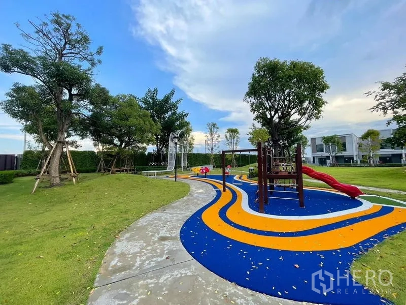 Townhouse for rent in Bang Phli, Samut Prakan - Colorful playground with slides and rubberized track in landscaped park.
