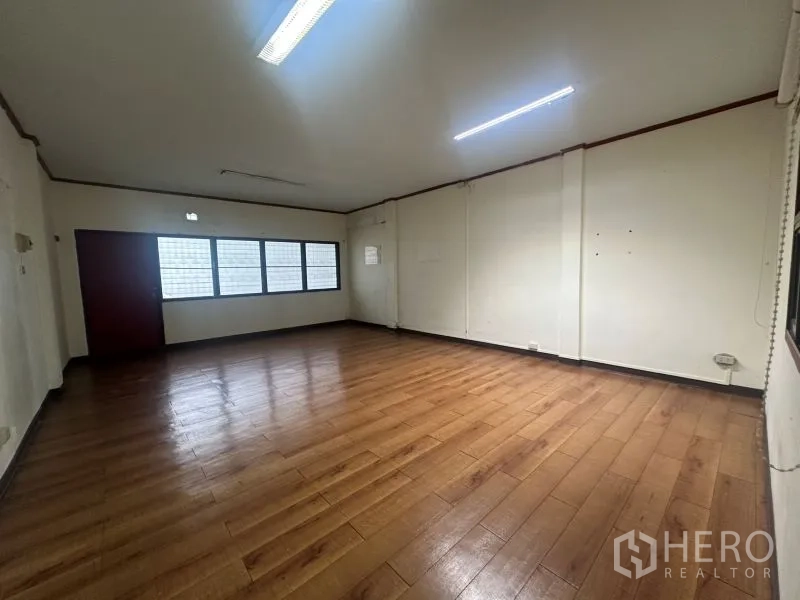 Office Space for rent - Large multipurpose room with wood-look flooring and fluorescent lights