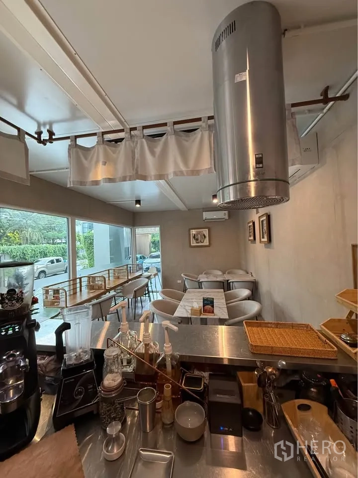 Retail Space for rent in Watthana, Bangkok - View from the counter to a bright dining area with upholstered chairs.