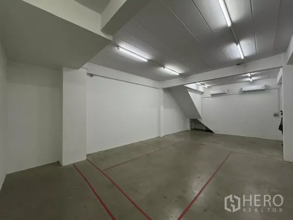 Factory for rent in Phra Samut Chedi, Samut Prakan - Open workspace with stairs and two wall-mounted air conditioners.