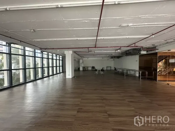 พื้นที่ขายปลีก ให้เช่า - ฮอลล์ค้าปลีกสว่าง ผนังกระจกยาว พื้นลายไม้ เสาโครงสร้าง