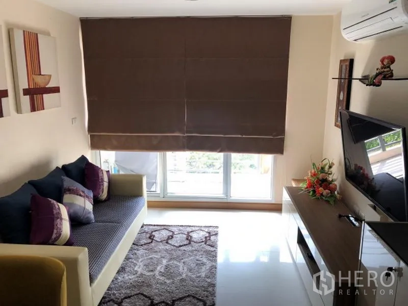 คอนโด ให้เช่าในKhlong Toei, Bangkok - ห้องนั่งเล่นมีหน้าต่างบานใหญ่พร้อมม่านทึบ โซฟา ชุดทีวี และพรมปูพื้น