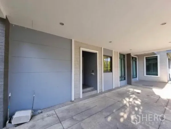 Detached House for sale in Suan Luang, Bangkok - Covered carport and entry porch with recessed lighting and large windows.