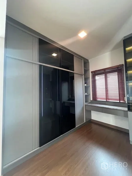 Detached House for rent or sale - Built-in sliding door wardrobe with dressing table by the window.