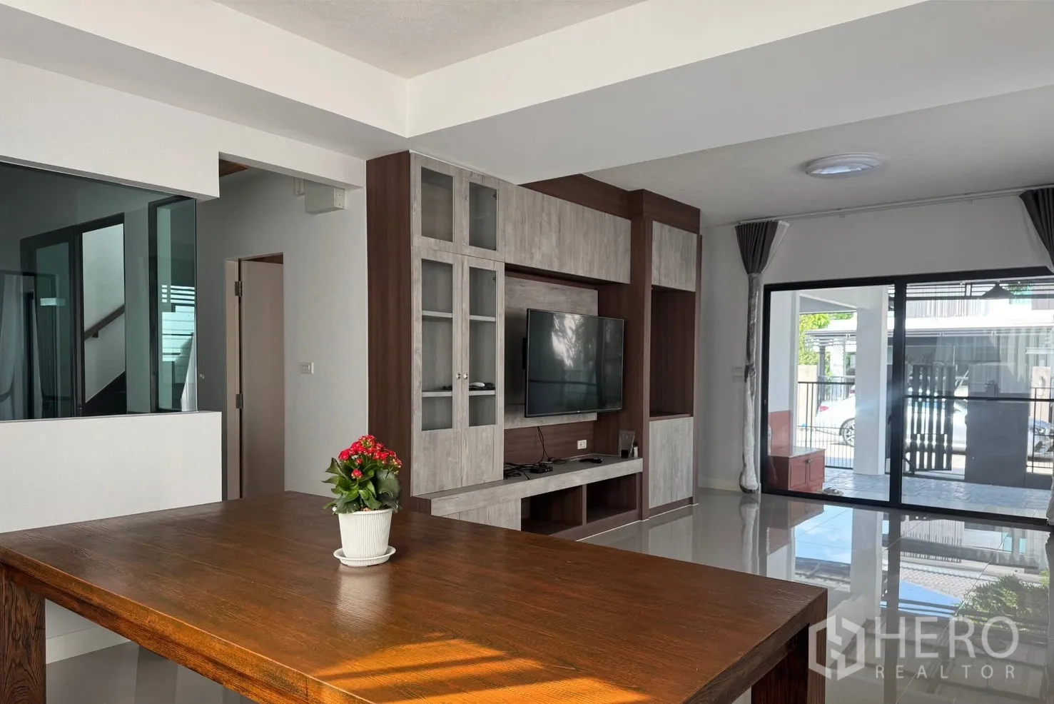 บ้าน for rent in Bang Phli, Samut Prakan - โถงนั่งเล่นแบบโอเพ่นแพลนมีผนังทีวีบิวท์อิน เชื่อมต่อไปยังเฉลียง