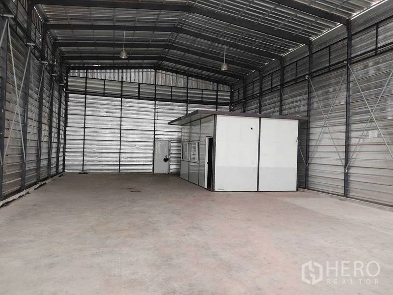 Warehouse for rent in Bang Phli, Samut Prakan - Wide open storage bay with internal office unit at the rear of the metal‑clad warehouse.