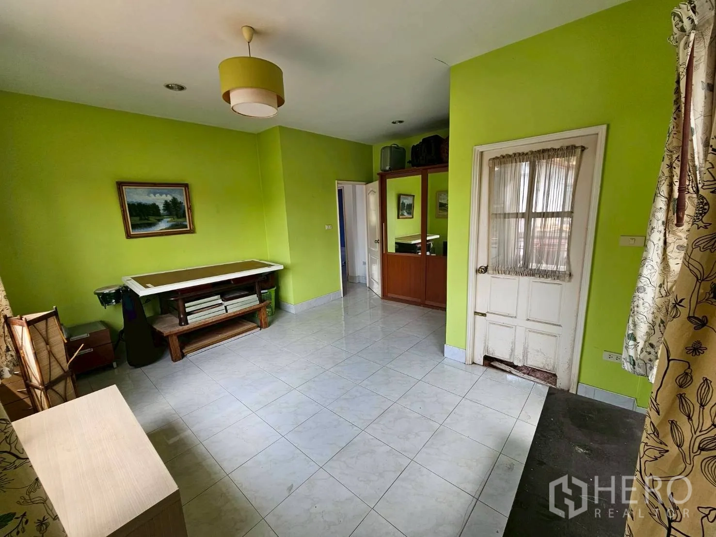 Detached House for rent or sale in Bang Lamung, Chon Buri - Second view of the green room showing built-in wardrobe and door to balcony.