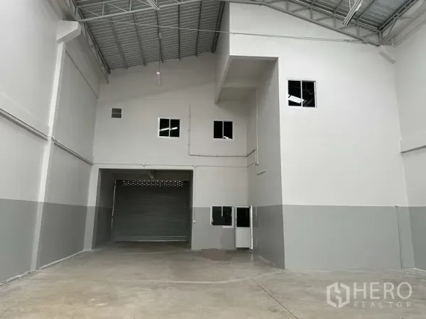 โรงงาน ให้เช่าในNonthaburi - ด้านหลังคลังสินค้า มีประตูม้วนใหญ่ บล็อกออฟฟิศภายใน และทางบริการ