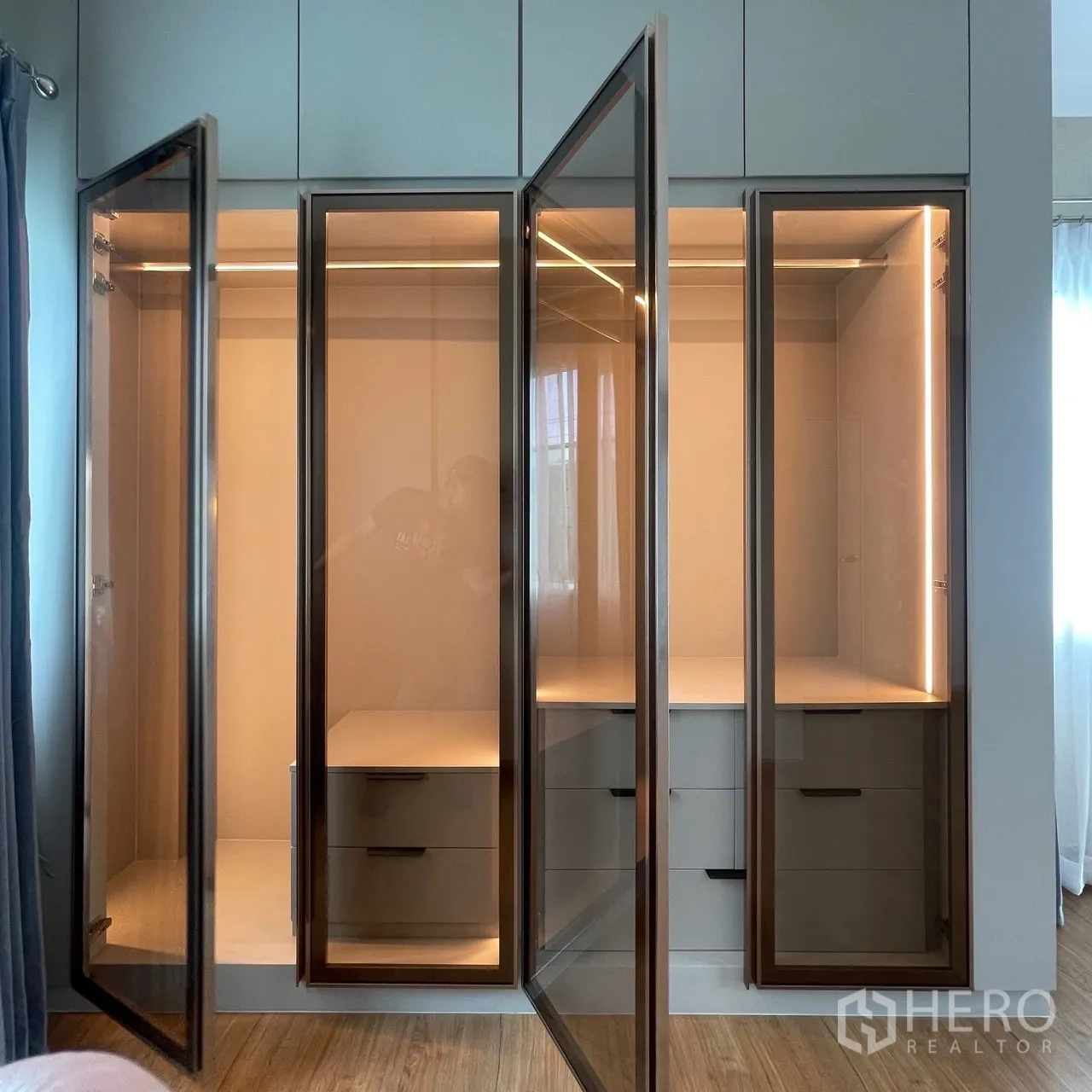 Semi-detached House for rent in Bang Phli, Samut Prakan - Built-in glass-door wardrobe with soft interior lighting and drawers in a modern bedroom.