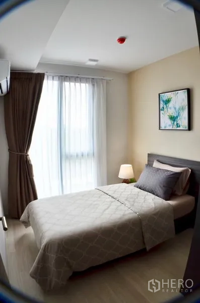 คอนโด ให้เช่าในWatthana, Bangkok - ห้องอเนกประสงค์ตกแต่งเป็นเตียงเดี่ยว พร้อมหน้าต่างบานใหญ่และโคมไฟข้างเตียง