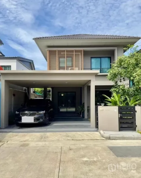 Detached House for rent in Samut Prakan - Modern two-storey detached house facade with covered two-car carport and gated entrance.