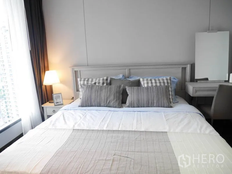 คอนโด ให้เช่าหรือขายในKhlong Toei, Bangkok - ห้องนอนโปร่งเตียงคิงไซซ์ โคมไฟหัวเตียง และโต๊ะเครื่องแป้งข้างหน้าต่างเต็มบาน