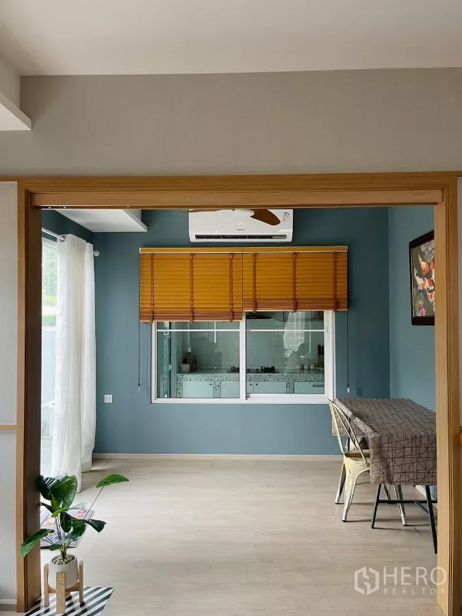 独立式住宅 出租在Prawet, Bangkok - 餐/多功能区，蓝色主墙，通过窗户可见泰式厨房