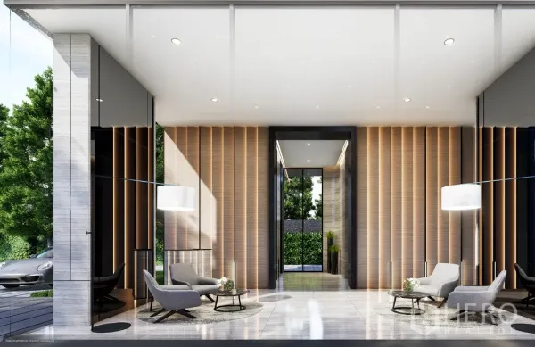 Condominium for sale in Watthana, Bangkok - Elegant lobby with high ceiling, lounge chairs and full‑height glass looking onto greenery.