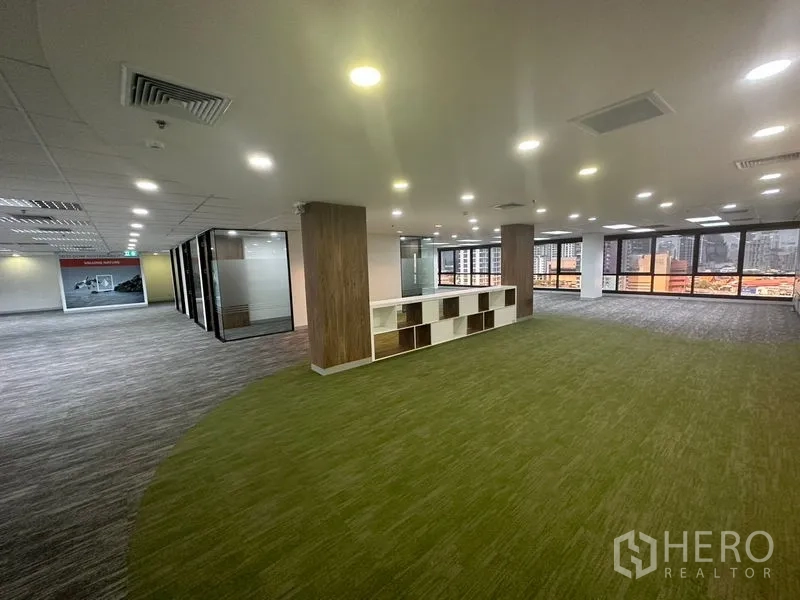 办公空间 出租在Khlong Toei, Bangkok - 协作区铺绿色地毯，置物格与宽阔城市景观。