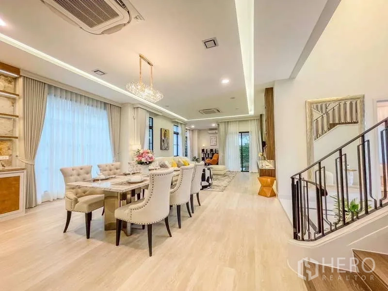 บ้าน ให้เช่าในSaphan Sung, Bangkok - พื้นที่นั่งเล่นและทานอาหารแบบโอเพ่นแพลน พื้นไม้สีอ่อน และประตูกระจก