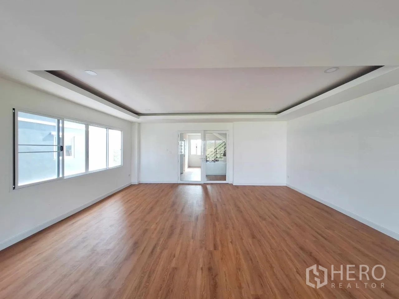 Home Office for sale in Bueng Kum, Bangkok - Large flexible workspace with timber floors and glass doors linking to the stairwell.