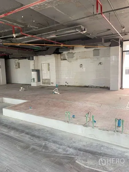 Retail Space for rent in Bang Rak, Bangkok - Back-of-house area with plumbing rough-ins, raised platforms and exposed piping for F&B use.