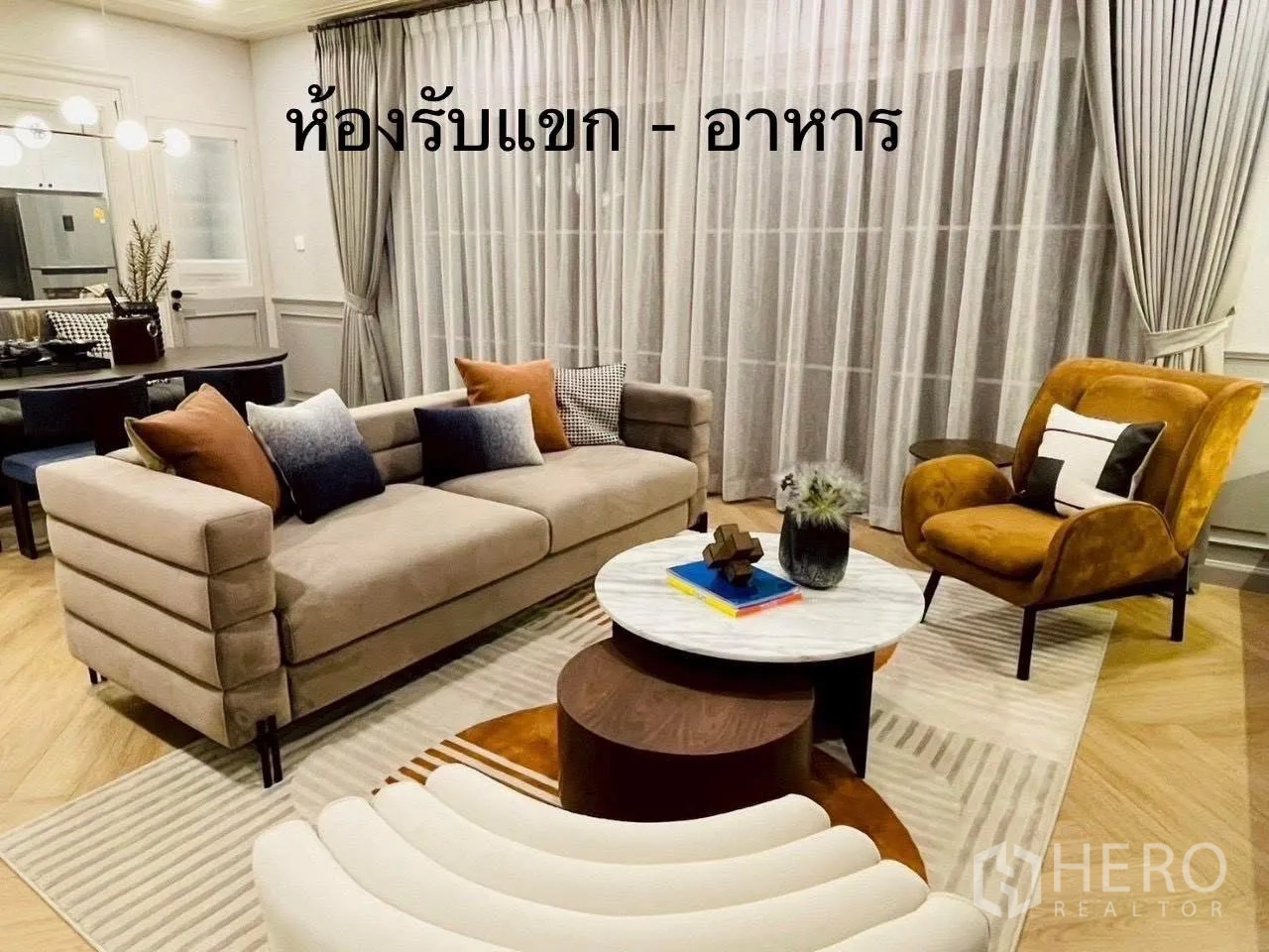 Detached House for rent in Bang Phli, Samut Prakan - Cozy living room with sofa set, armchair, and floor-to-ceiling curtains.