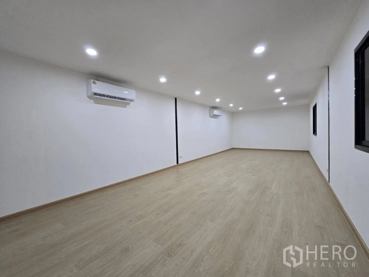 Warehouse for rent - Long air-conditioned office space with windows and light wood flooring, ready for fit-out.