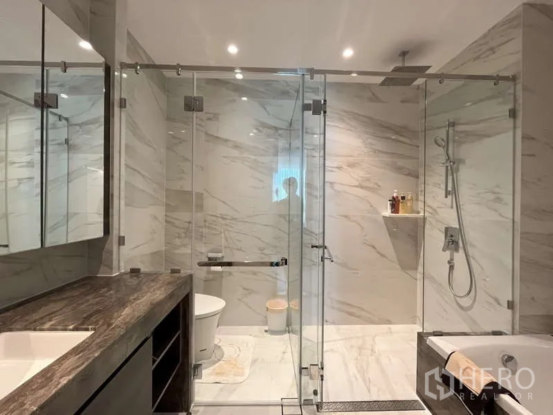 คอนโด ให้เช่าหรือขายในSathon, Bangkok - ห้องน้ำกว้างพร้อมตู้กั้นกระจกคู่ เรนชาวเวอร์ และกระเบื้องลายหินอ่อน