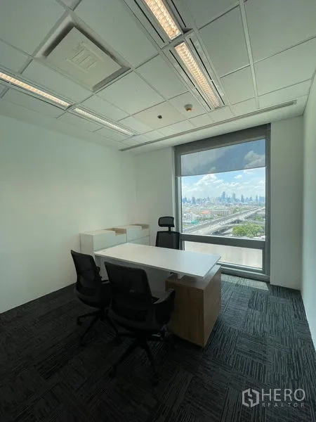 Office Space for rent in Dusit, Bangkok - Private office with desk and chairs facing a large window with Bangkok skyline view.
