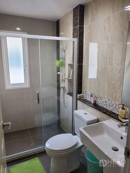 Detached House for sale in Bueng Kum, Bangkok - Second bathroom with sliding glass shower door and window for light.