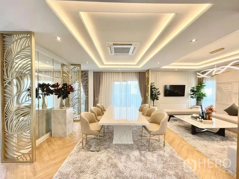 Detached House for rent in Bang Phli, Samut Prakan - Open-plan dining and living room with long table and LED coffered ceilings.