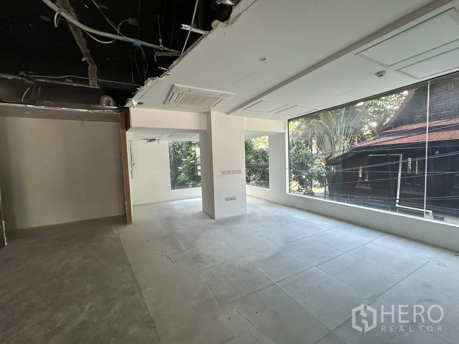 Retail Space for rent in Watthana, Bangkok - Bright corner space with oversized windows overlooking greenery.