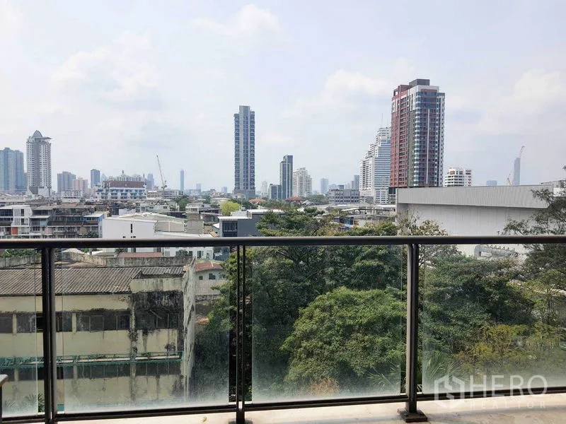 Condominium for rent in Yan Nawa, Bangkok - Balcony view across trees to Bangkok city skyline.