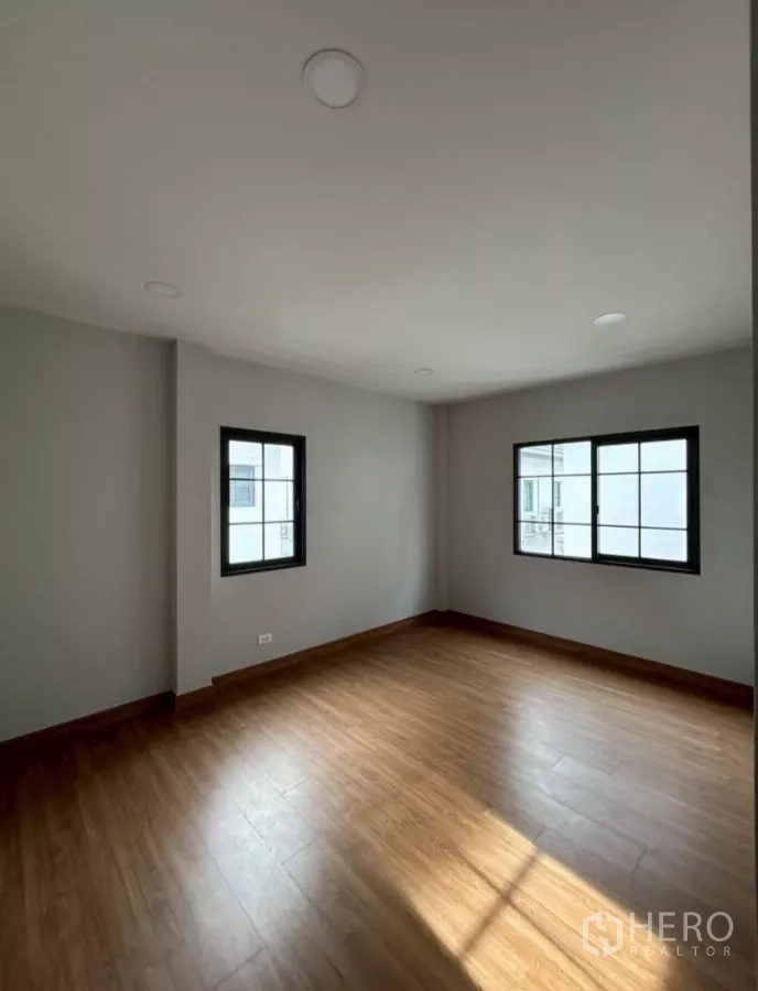 独立式住宅 出租在Bang Phli, Samut Prakan - 转角卧室，木地板，两扇窗采光充足。