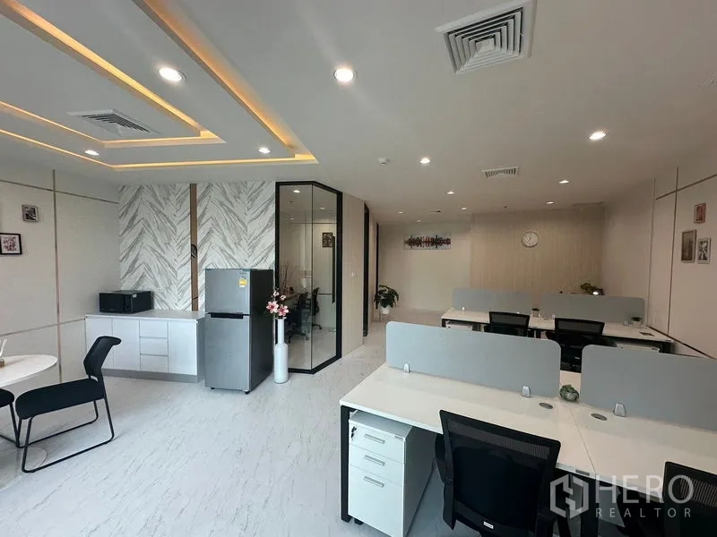 Office Space for rent - Modern open office layout with desks, accent ceiling and glass‑walled room.