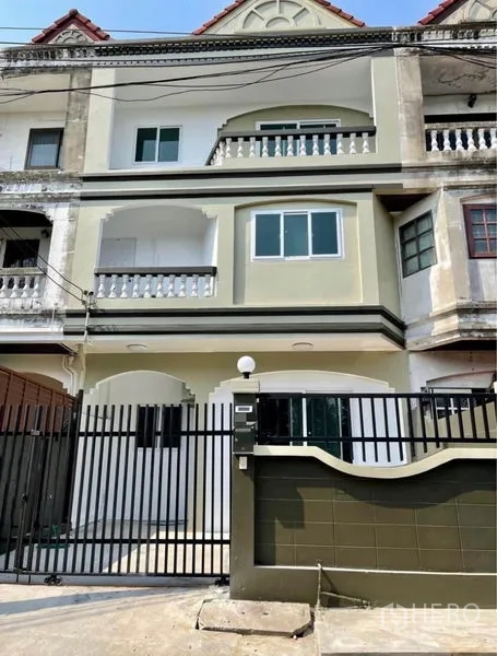 Townhouse for rent - Three-storey gated townhouse exterior with balconies and updated windows.