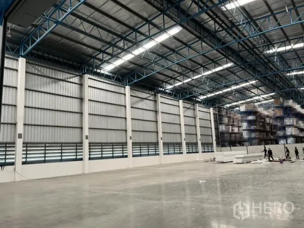 Warehouse for rent in Lat Krabang, Bangkok - Wide warehouse wall with metal cladding, ventilation louvers and high ceiling structure