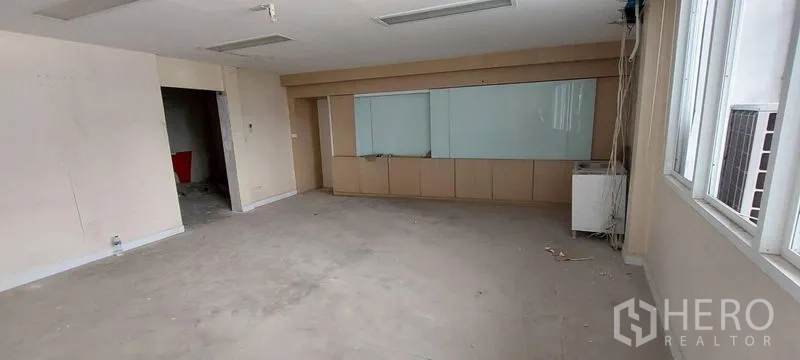 Shophouse for sale - Large vacant workspace with built-in cabinet and whiteboard panel.