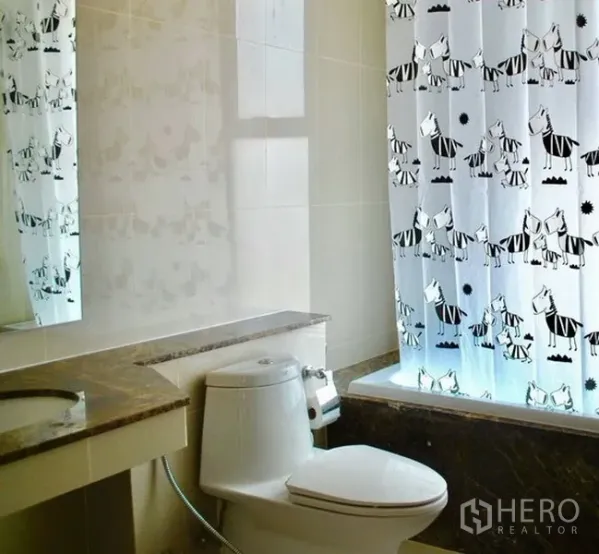 คอนโด ให้เช่าในWatthana, Bangkok - ห้องน้ำสะอาดพร้อมอ่างอาบน้ำ เคาน์เตอร์หินอ่อน และม่านอาบน้ำลายกราฟิก
