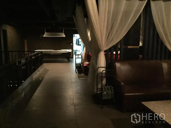 พื้นที่ขายปลีก ให้เช่าในWatthana, Bangkok - โถงชั้นบนกั้นม่าน มีโซฟาหนังและโต๊ะพูลคลุมผ้า